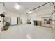 Spacious two-car garage with speckled floor and ample storage for vehicles and other household items at 6407 Sw 45Th Ave, Ocala, FL 34474