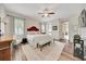 Spacious main bedroom with a ceiling fan, wood floors and an attached seating area creates a cozy retreat at 6407 Sw 45Th Ave, Ocala, FL 34474