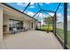 Screened-in lanai with neutral floors has seating and view of the lawn at 6407 Sw 45Th Ave, Ocala, FL 34474