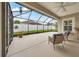 Covered screened patio featuring neutral concrete floors and framed view of the backyard at 6407 Sw 45Th Ave, Ocala, FL 34474