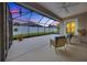 Covered screened patio featuring neutral concrete floors and framed view of the backyard at 6407 Sw 45Th Ave, Ocala, FL 34474