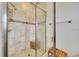 Glass-enclosed shower with tiled walls, mosaic accents, and a built-in shower seat at 6407 Sw 45Th Ave, Ocala, FL 34474