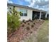 Landscaped backyard with flowering tree and patio area at 7682 Sw 89Th Ct, Ocala, FL 34481