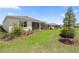 Manicured backyard of home features lush green grass and professional landscaping at 7682 Sw 89Th Ct, Ocala, FL 34481