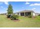 Spacious green backyard features a covered patio perfect for relaxing and entertaining at 7682 Sw 89Th Ct, Ocala, FL 34481