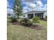 Beautiful backyard features a screened lanai and mature trees at 7682 Sw 89Th Ct, Ocala, FL 34481