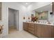 Bright bathroom with double vanity, modern fixtures, and doorway leading to separate room and closet at 7682 Sw 89Th Ct, Ocala, FL 34481