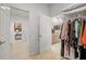 Hallway view of laundry room, bathroom, and closet, showcasing storage solutions and organizational features at 7682 Sw 89Th Ct, Ocala, FL 34481