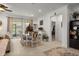 Open-concept dining area with stylish furniture, seamlessly connected to the living space, bright and inviting at 7682 Sw 89Th Ct, Ocala, FL 34481