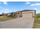 House exterior showcasing a well-maintained lawn and driveway at 7682 Sw 89Th Ct, Ocala, FL 34481