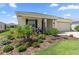 Landscaped front yard featuring lush plants and decorative accents enhancing curb appeal at 7682 Sw 89Th Ct, Ocala, FL 34481