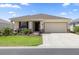 Charming single-story home featuring a well-manicured lawn and an attached two-car garage at 7682 Sw 89Th Ct, Ocala, FL 34481