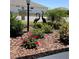 Professionally landscaped front yard with colorful flowers and decorative statues at 7682 Sw 89Th Ct, Ocala, FL 34481