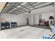 Spacious garage with an open overhead door and plenty of storage space at 7682 Sw 89Th Ct, Ocala, FL 34481