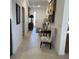Bright hallway with tile flooring, decor, and a view of the front door at 7682 Sw 89Th Ct, Ocala, FL 34481