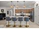 Bright kitchen features a large island with seating, stainless steel appliances, and modern pendant lighting at 7682 Sw 89Th Ct, Ocala, FL 34481