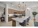 Stylish kitchen showcasing an island with barstool seating, stainless steel appliances, and decorative seashell accents at 7682 Sw 89Th Ct, Ocala, FL 34481