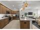 Modern kitchen with stainless steel appliances, a spacious island, and sleek countertops at 7682 Sw 89Th Ct, Ocala, FL 34481
