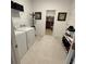 Laundry room with modern appliances, overhead storage and coat rack, leads to closet at 7682 Sw 89Th Ct, Ocala, FL 34481