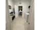 Entry view of a well-lit laundry room featuring modern appliances and ample space at 7682 Sw 89Th Ct, Ocala, FL 34481