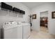 Clean laundry room with washer, dryer, storage shelf and door to walk-in closet at 7682 Sw 89Th Ct, Ocala, FL 34481
