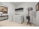 Bright laundry room equipped with washer, dryer and storage shelf, plus a side table at 7682 Sw 89Th Ct, Ocala, FL 34481