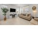 Cozy living room featuring stylish decor, a modern fireplace, and neutral tones, perfect for relaxation at 7682 Sw 89Th Ct, Ocala, FL 34481