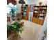 Relaxing living room area with rattan furniture, bookcases and lots of plants at 7682 Sw 89Th Ct, Ocala, FL 34481