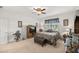 Comfortable primary bedroom with decorative ceiling fan, TV, bench, and windows providing natural light at 7682 Sw 89Th Ct, Ocala, FL 34481