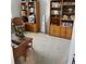 Cozy office featuring built-in bookshelves and comfortable wicker seating at 7682 Sw 89Th Ct, Ocala, FL 34481