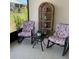 Relaxing patio with rocking chairs and a view of the landscaped backyard at 7682 Sw 89Th Ct, Ocala, FL 34481