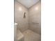 Close up of the beige tiled shower with built-in bench and chrome fixtures at 7682 Sw 89Th Ct, Ocala, FL 34481
