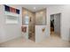 Modern bathroom with walk-in shower, glass enclosure, tiled walls, and doorway view of closet space at 7682 Sw 89Th Ct, Ocala, FL 34481