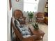 Cozy sitting area with wicker furniture, floral cushions, and a view to the window at 7682 Sw 89Th Ct, Ocala, FL 34481