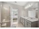 Modern bathroom with double vanity, large mirror, and walk-in shower at 8456 Sw 52Nd Lane Rd, Ocala, FL 34481