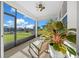 Spacious screened porch overlooking the backyard with ceiling fan at 8456 Sw 52Nd Lane Rd, Ocala, FL 34481