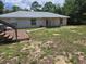 Back yard with a deck, green space, and mature trees at 113 Guava Ter, Ocklawaha, FL 32179