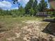 Expansive backyard featuring a deck with a hot tub and ample space for outdoor activities at 113 Guava Ter, Ocklawaha, FL 32179
