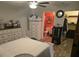 Cozy bedroom featuring a ceiling fan, and an ensuite bathroom with rustic wood-look flooring at 113 Guava Ter, Ocklawaha, FL 32179