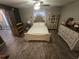 Comfortable bedroom featuring a cozy queen-size bed, dresser, tile flooring, and natural lighting at 113 Guava Ter, Ocklawaha, FL 32179