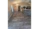 Open dining area with a stylish chandelier, tile flooring, and a view of the kitchen at 113 Guava Ter, Ocklawaha, FL 32179
