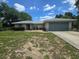 Charming single-story home with a well-maintained lawn, mature trees, and an attached two-car garage at 113 Guava Ter, Ocklawaha, FL 32179