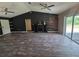 Spacious living room featuring wood-like tile floors, a decorative fireplace, and large windows at 113 Guava Ter, Ocklawaha, FL 32179