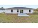 Rear view of house, patio, and yard at 127 Marion Oaks Golf Way, Ocala, FL 34473