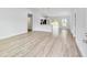 Spacious living room with light gray walls and wood-look vinyl flooring at 127 Marion Oaks Golf Way, Ocala, FL 34473