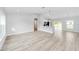 Open-concept living room featuring light gray walls and wood-look vinyl flooring at 127 Marion Oaks Golf Way, Ocala, FL 34473