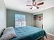 Cozy bedroom with a ceiling fan, wood-look floors, and built-in shelving at 21343 Sw Plantation St, Dunnellon, FL 34431