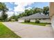 Long driveway with space for multiple cars and green landscaping at 2215 Se Spring Hill Ct, Ocala, FL 34471