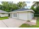 One-car garage with additional storage room and brick walkway at 2215 Se Spring Hill Ct, Ocala, FL 34471