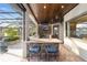 Outdoor kitchen with granite countertops, stainless steel appliances, and a stone facade at 2802 Se 28Th St, Ocala, FL 34471